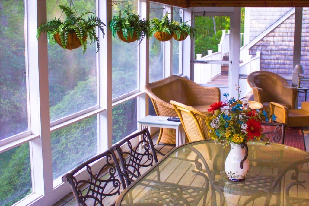 porch screen at a home with plants and a table